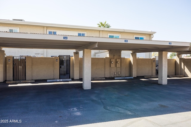 covered parking lot with fence and a gate