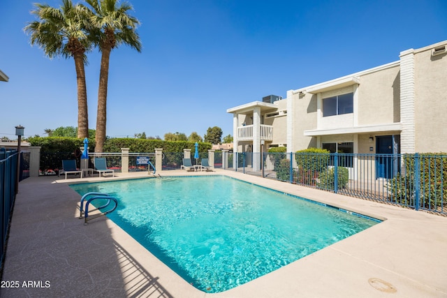 pool featuring a patio area and fence