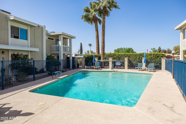 pool featuring a patio and fence