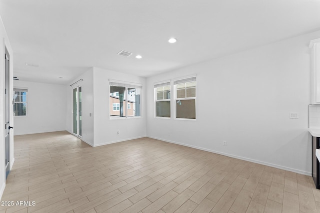 unfurnished living room with light hardwood / wood-style floors