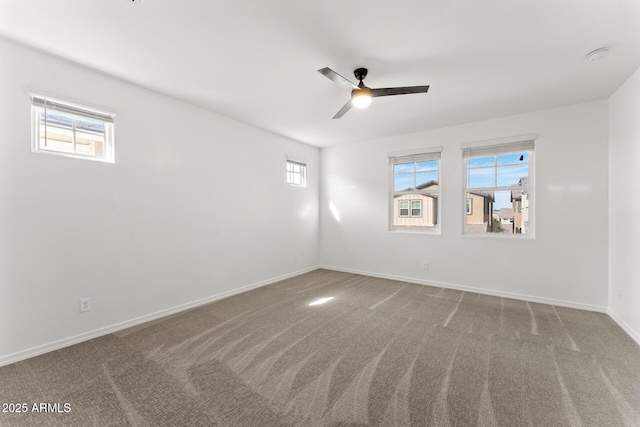 spare room with carpet floors and ceiling fan