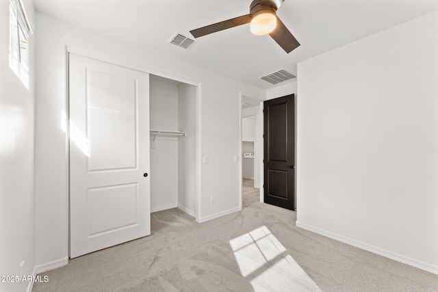 unfurnished bedroom featuring light carpet, ceiling fan, and a closet