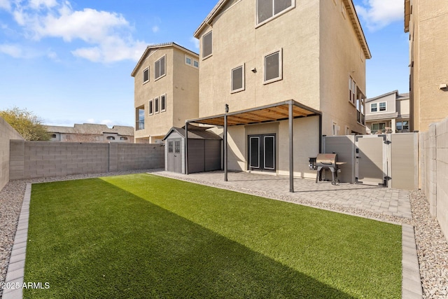 rear view of house with a shed, a patio area, and a lawn