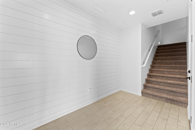 interior space featuring wood-type flooring and wooden walls