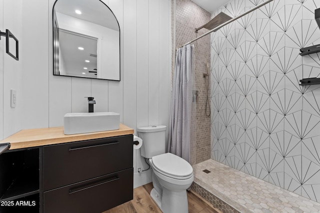 bathroom with vanity, hardwood / wood-style floors, a shower with curtain, and toilet