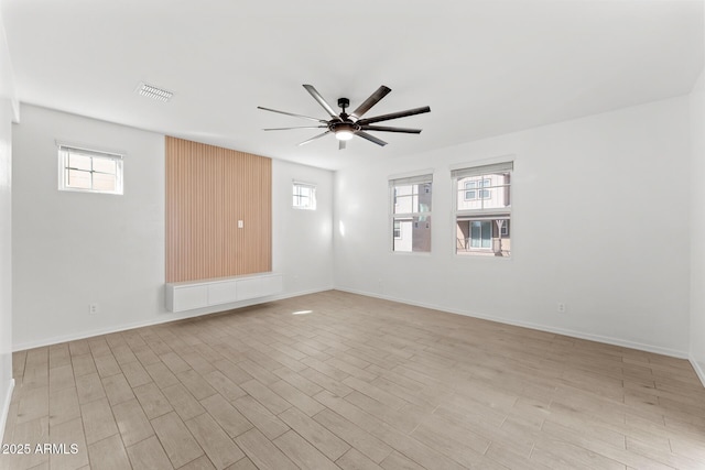 spare room featuring ceiling fan and light hardwood / wood-style flooring