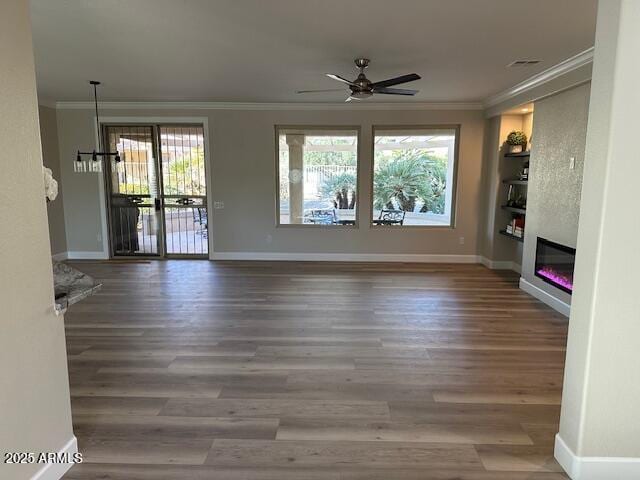 unfurnished living room with ceiling fan, ornamental molding, and hardwood / wood-style flooring