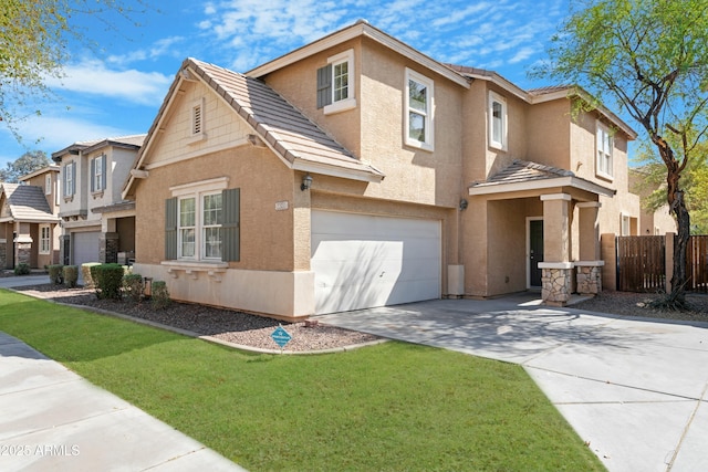 traditional home with stucco siding, driveway, a garage, and fence