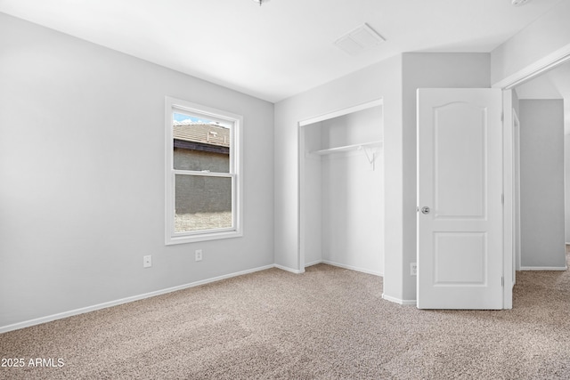 unfurnished bedroom with a closet, baseboards, light colored carpet, and visible vents