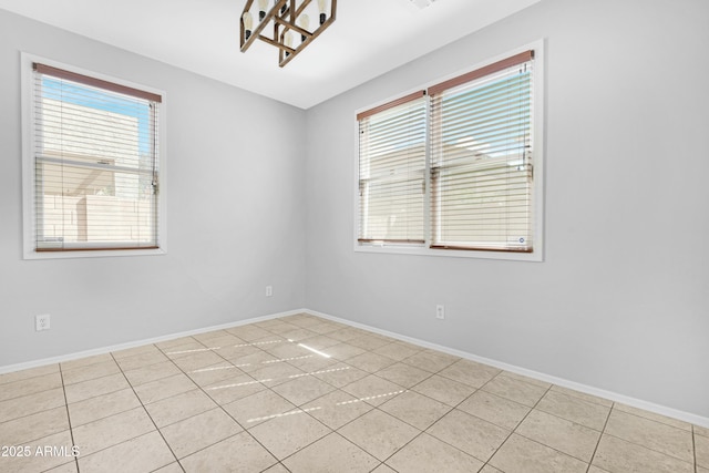 unfurnished room with baseboards and light tile patterned flooring