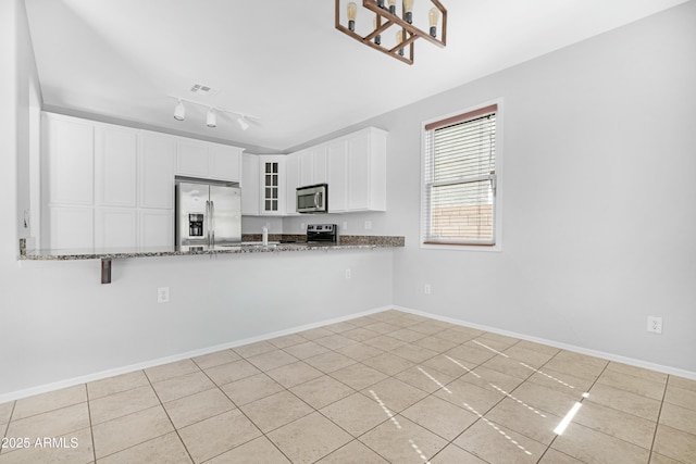 kitchen featuring visible vents, stone countertops, glass insert cabinets, appliances with stainless steel finishes, and white cabinetry