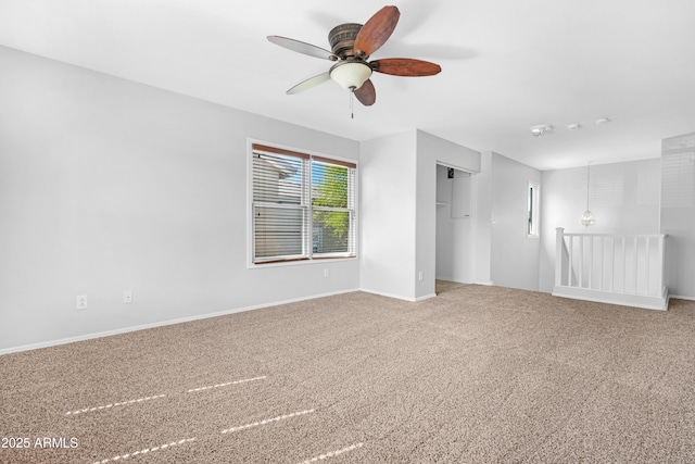 empty room with ceiling fan, baseboards, and carpet floors