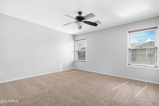 carpeted empty room featuring visible vents, baseboards, and ceiling fan