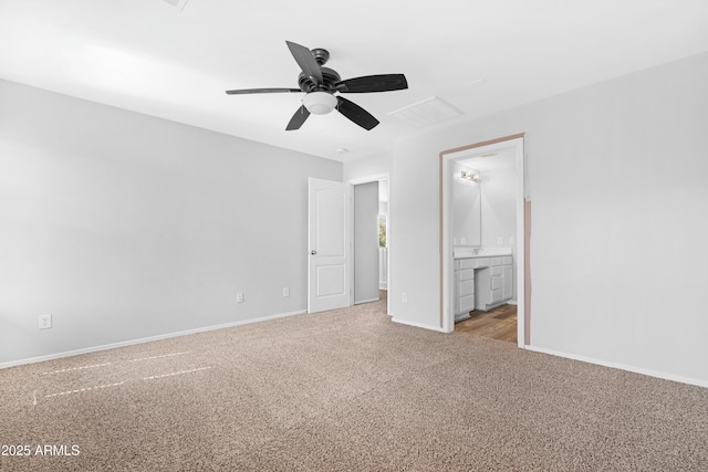 unfurnished bedroom with carpet flooring, connected bathroom, baseboards, and ceiling fan