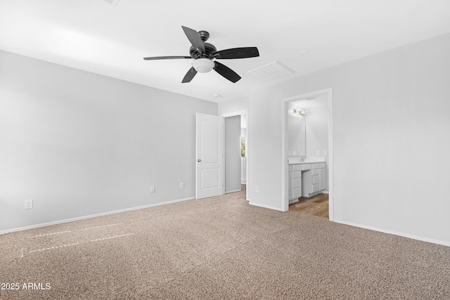 unfurnished bedroom featuring visible vents, baseboards, ensuite bath, and carpet flooring