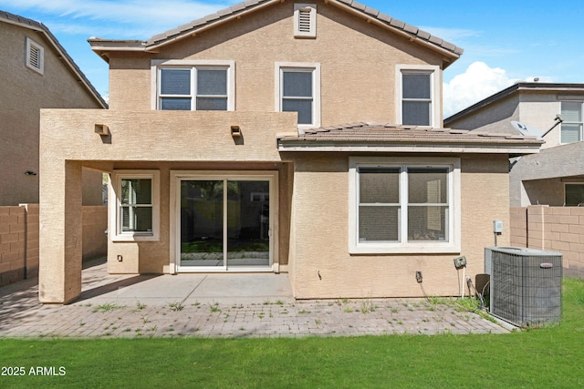 back of house featuring a patio, fence, stucco siding, a tile roof, and central air condition unit