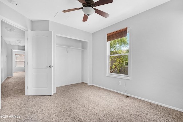 unfurnished bedroom with a ceiling fan, carpet, a closet, and baseboards