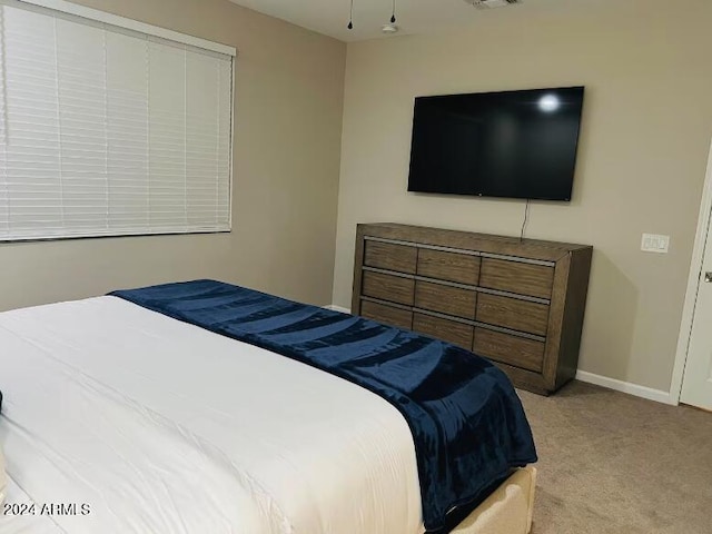 bedroom featuring light colored carpet