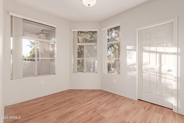 interior space with baseboards and wood finished floors