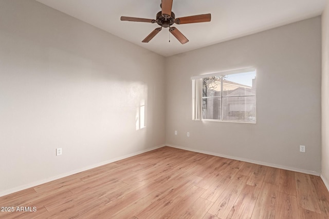 unfurnished room featuring baseboards, light wood-style floors, and a ceiling fan