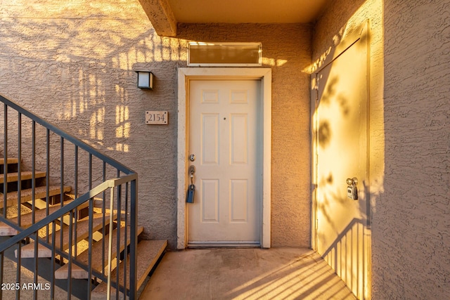 property entrance with stucco siding