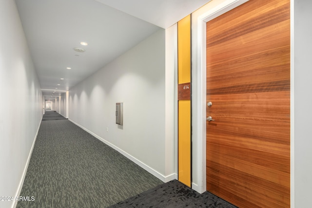 corridor with dark colored carpet