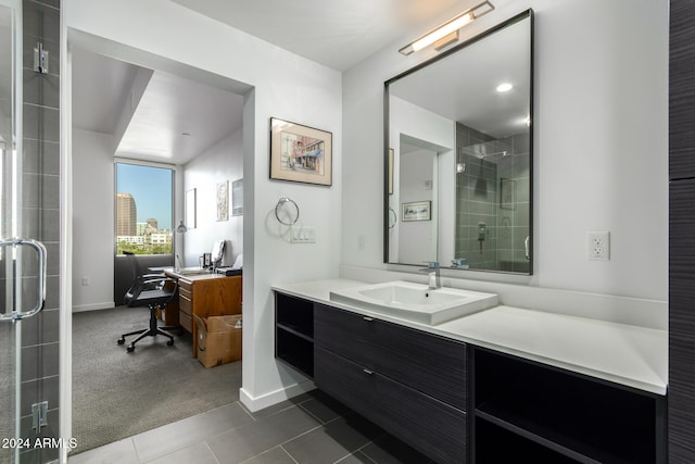 bathroom with tile patterned flooring, vanity, and a shower with shower door