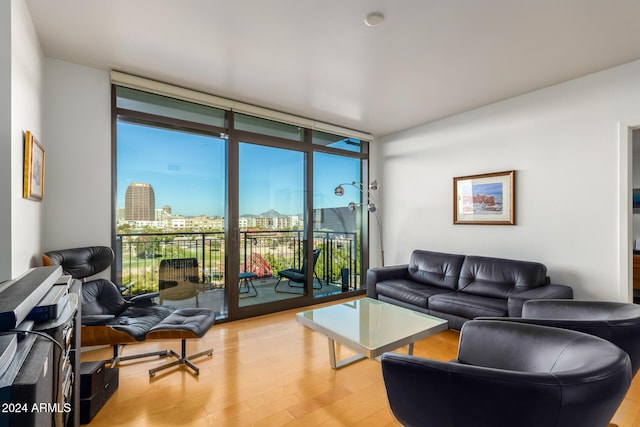 living room featuring light hardwood / wood-style flooring and a wall of windows