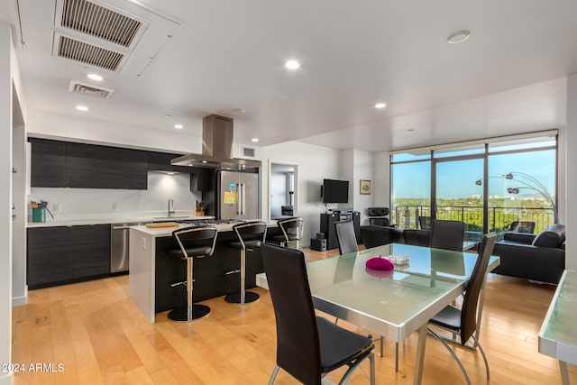 dining room with sink and light hardwood / wood-style floors