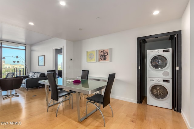 dining room with light hardwood / wood-style flooring and stacked washer and clothes dryer