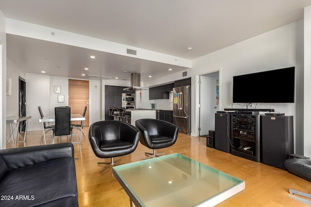 living room featuring beverage cooler and light wood-type flooring