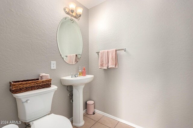 bathroom with sink, tile patterned floors, and toilet