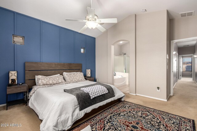 bedroom with light colored carpet, ceiling fan, and ensuite bathroom