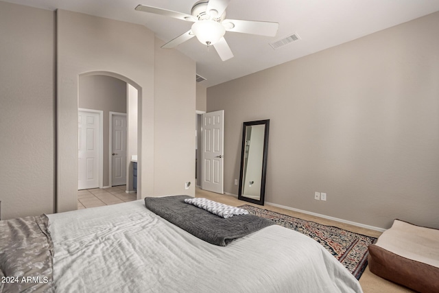 tiled bedroom with high vaulted ceiling and ceiling fan