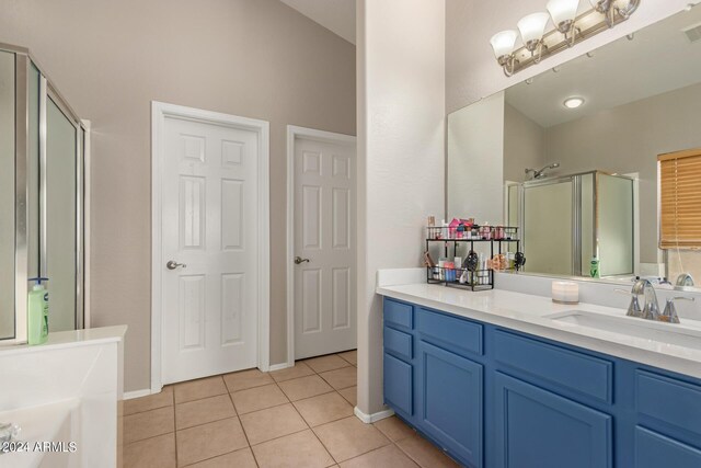 bathroom with tile patterned flooring, vanity, and separate shower and tub