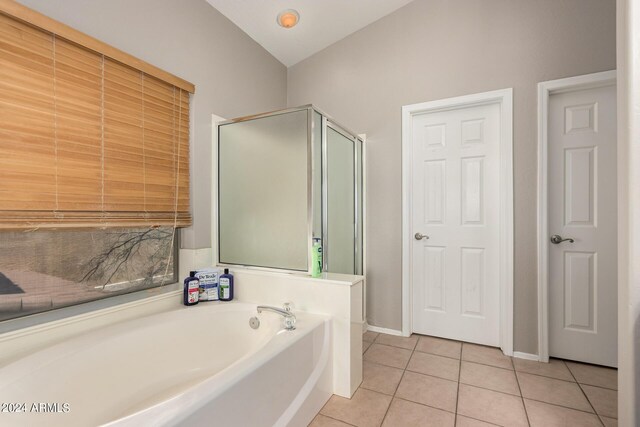 bathroom featuring tile patterned floors and shower with separate bathtub