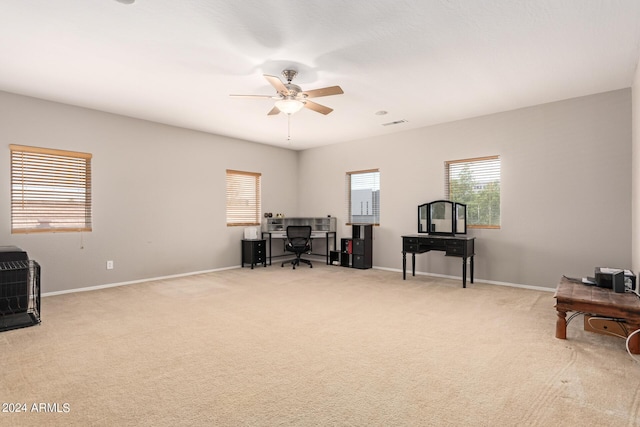 home office featuring light colored carpet and ceiling fan