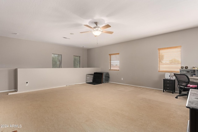 office with light carpet and ceiling fan