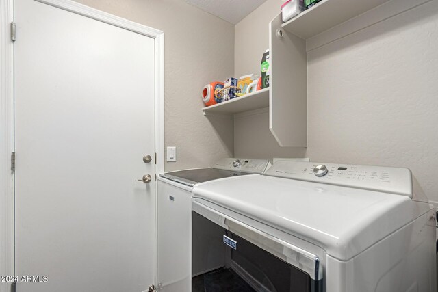 washroom featuring washer and clothes dryer