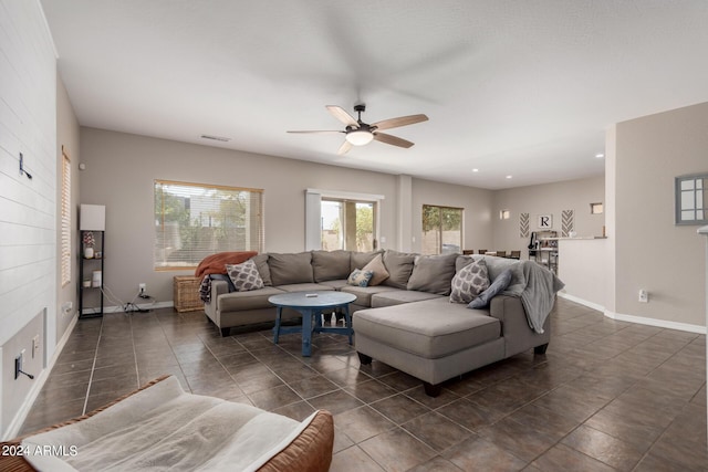 tiled living room featuring ceiling fan