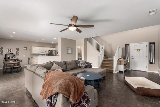 tiled living room with ceiling fan