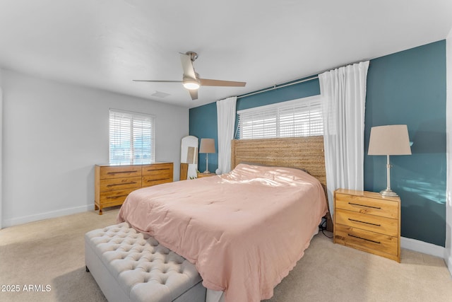 bedroom featuring light colored carpet and ceiling fan