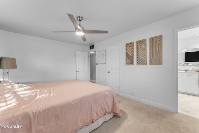 carpeted bedroom featuring ceiling fan and connected bathroom