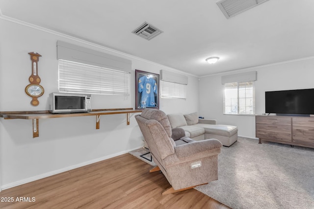 living room featuring cooling unit, crown molding, and wood-type flooring