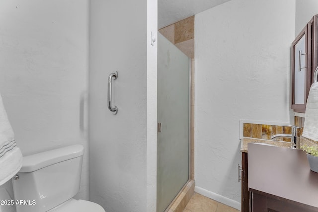 bathroom featuring toilet, a shower with door, vanity, and tile patterned floors