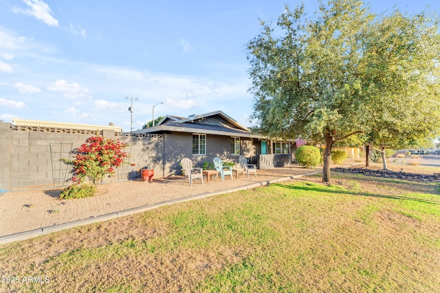 rear view of house featuring a yard