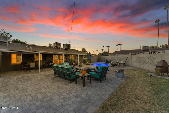 patio terrace at dusk featuring a swimming pool, a lawn, central air condition unit, and outdoor lounge area