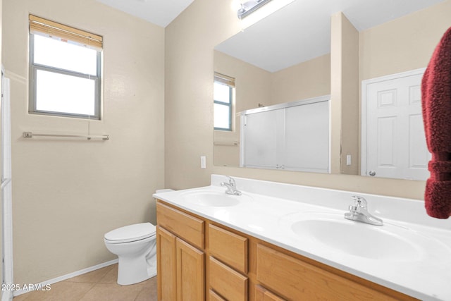 bathroom featuring toilet, an enclosed shower, tile patterned flooring, and vanity