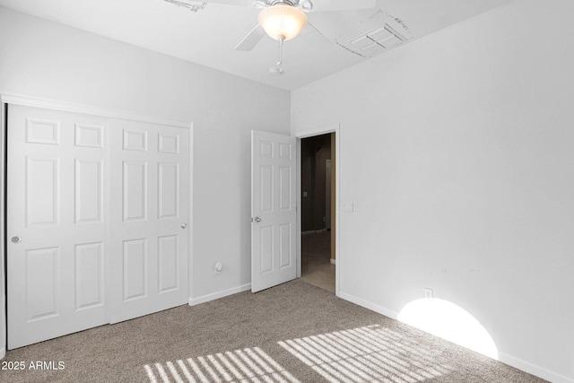 unfurnished bedroom with ceiling fan, a closet, and carpet floors