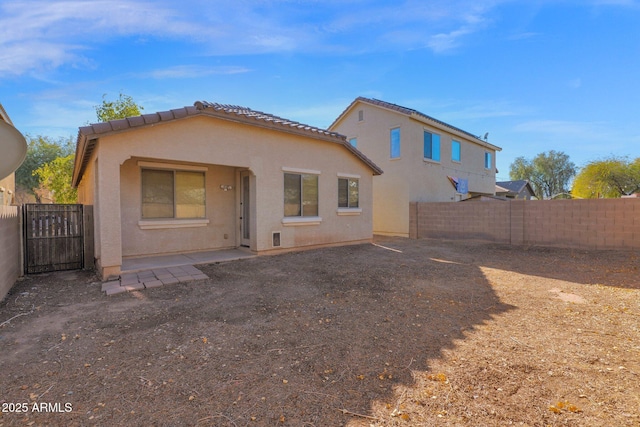 rear view of property featuring a patio